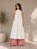 White cotton halter neck kurta paired with cotton tie-dye palazzo pants for women.