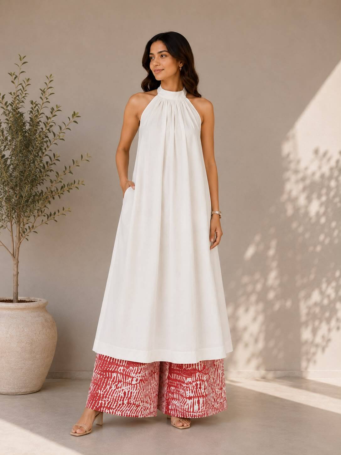 White cotton halter neck kurta paired with cotton tie-dye palazzo pants for women.