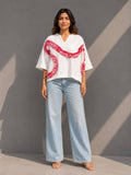 Women's white cotton top featuring handcrafted tie-dye patch detailing and a relaxed fit.