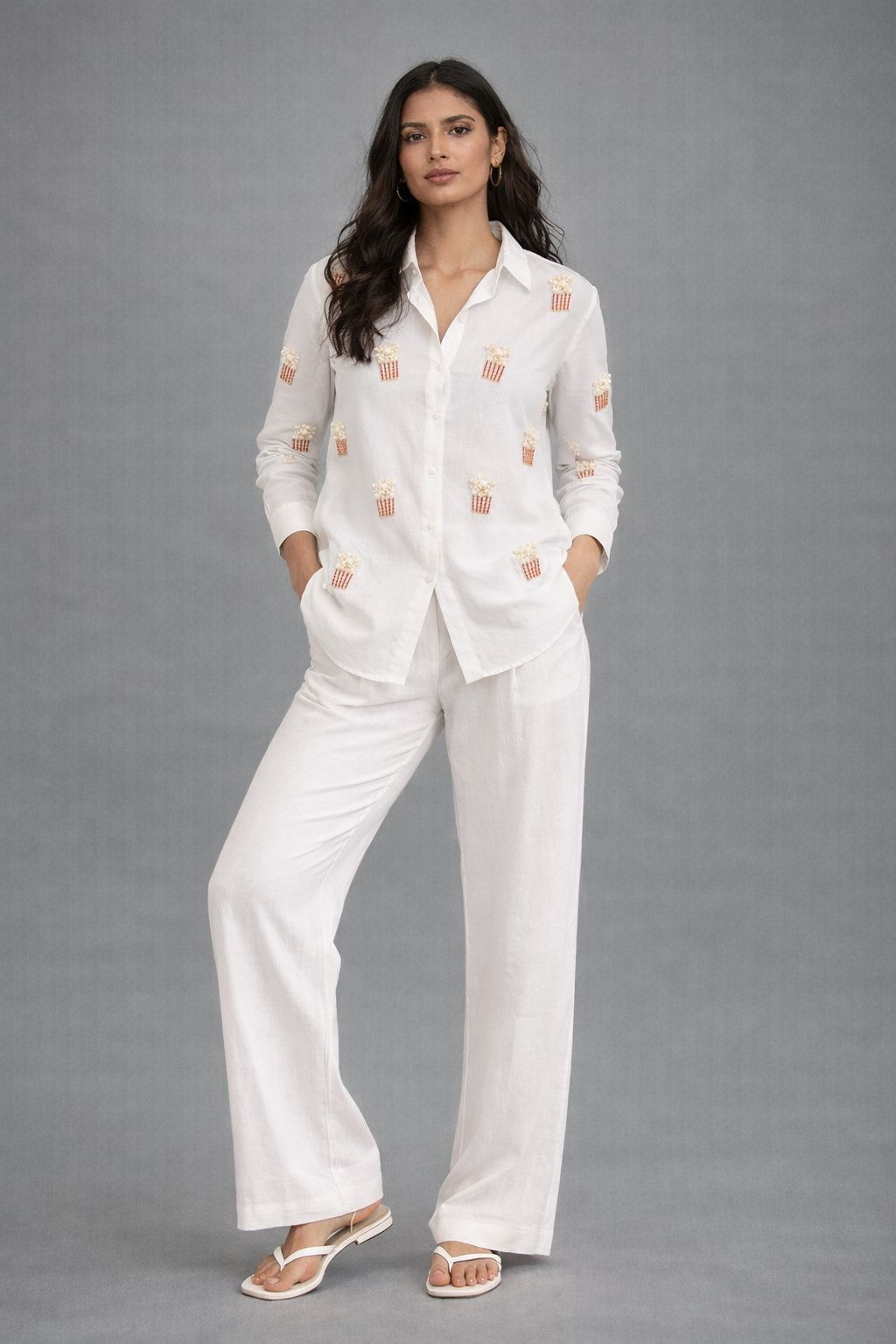 Women’s white shirt with popcorn embroidery styled with white trousers
