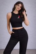 Black fitted ribbed crop tank styled with wide-leg trousers and sneakers